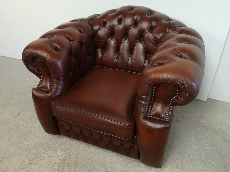Curved brown leather chesterfield armchair