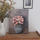 Painting of a bunch of coral-colored peonies in a gray vase