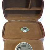 Small travel alarm clock in its case with jewelry compartments
