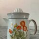 Vintage stoneware jug and its citrus juicer.