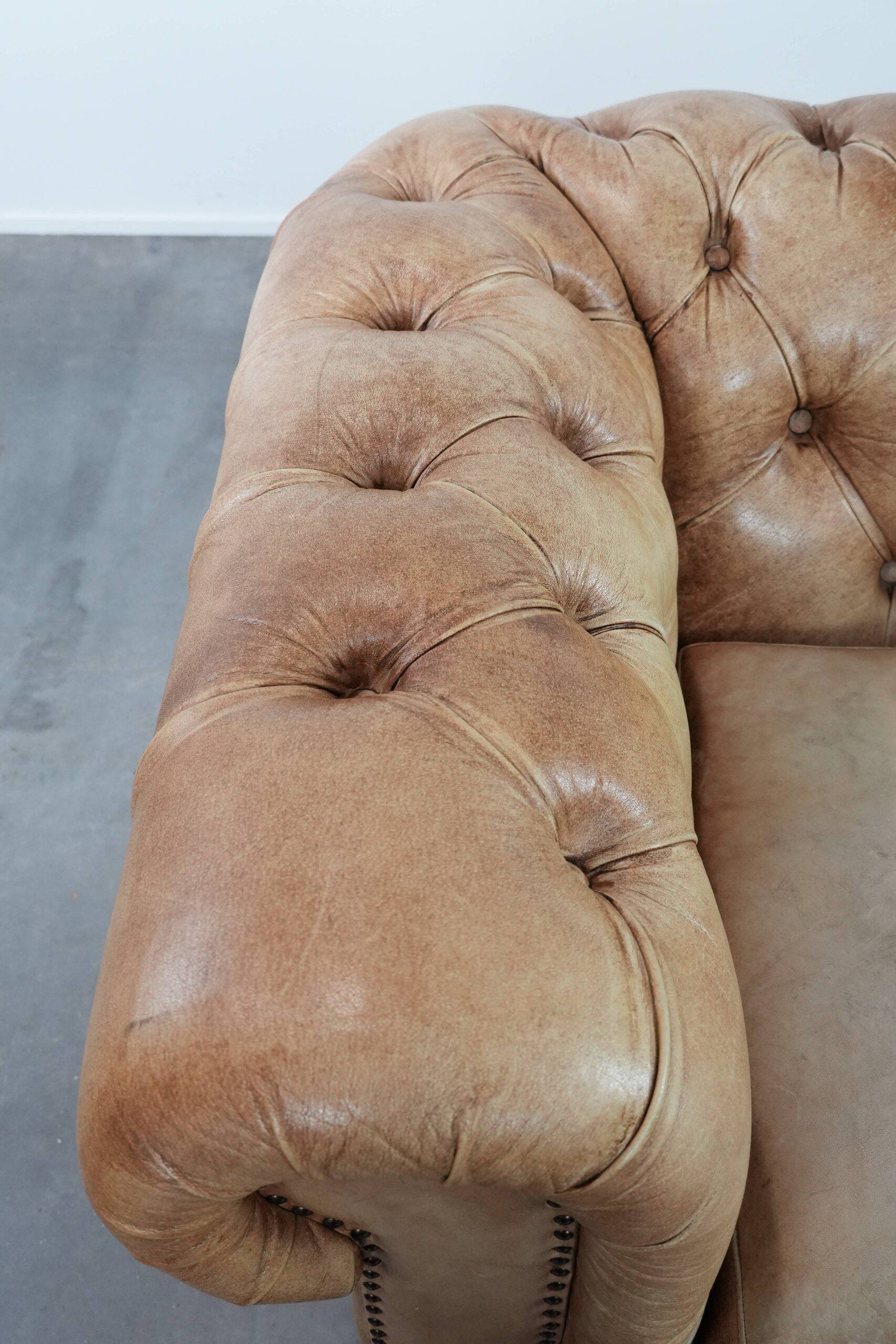 Chesterfield armchair made of cowhide leather in a light cognac colour