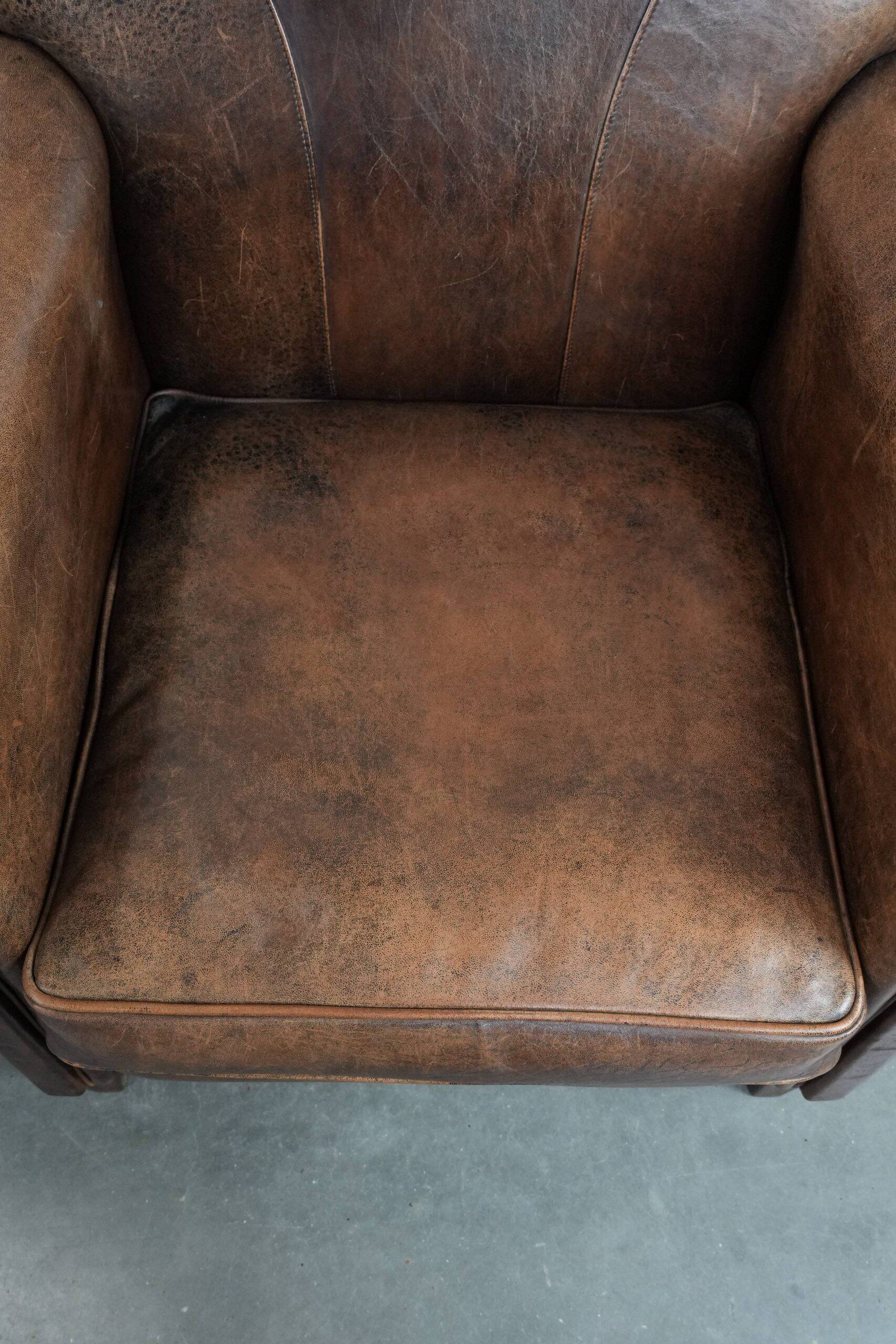 Set of 2 vintage sheepskin armchairs with a characterful appearance