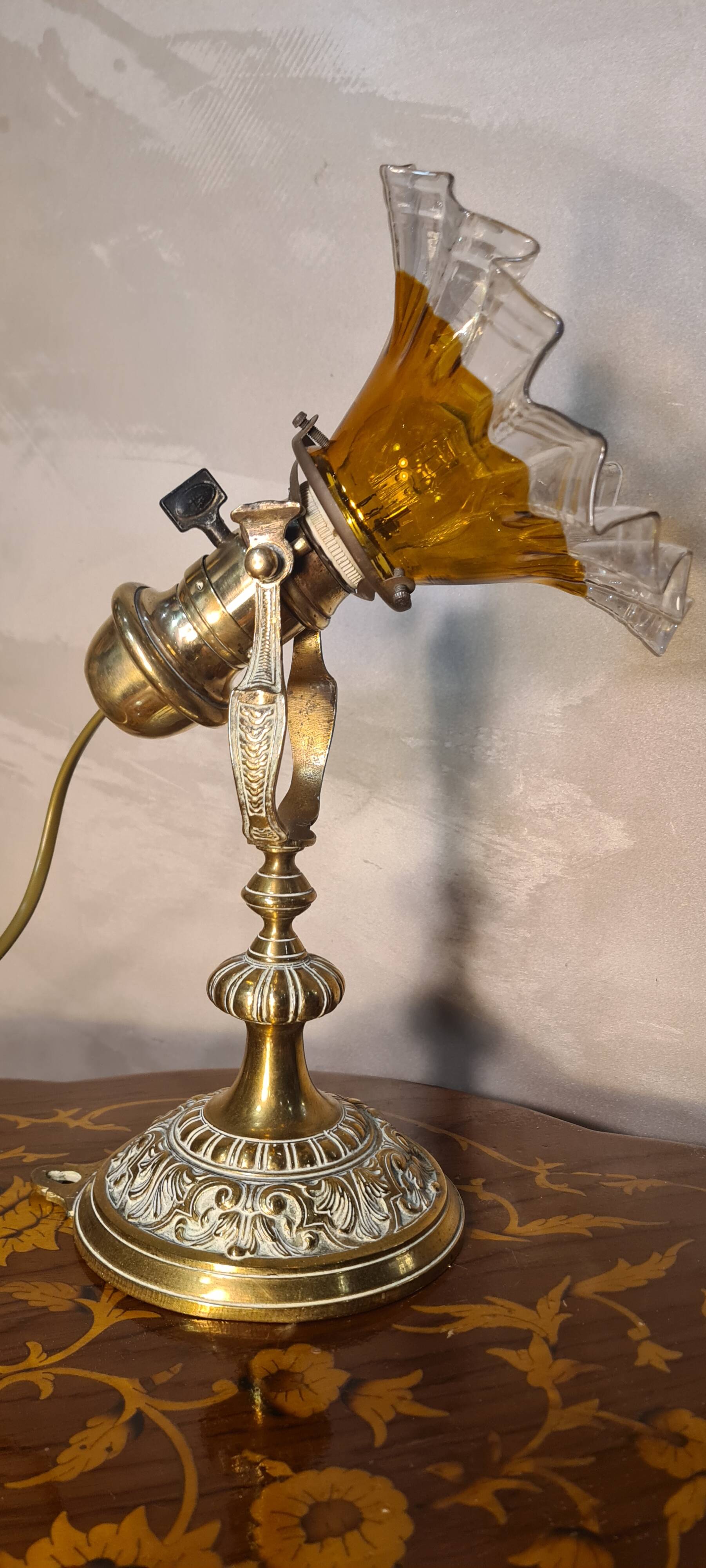 1920 bronze and brass rocking lamp with translucent amber-colored shade