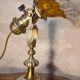1920 bronze and brass rocking lamp with translucent amber-colored shade