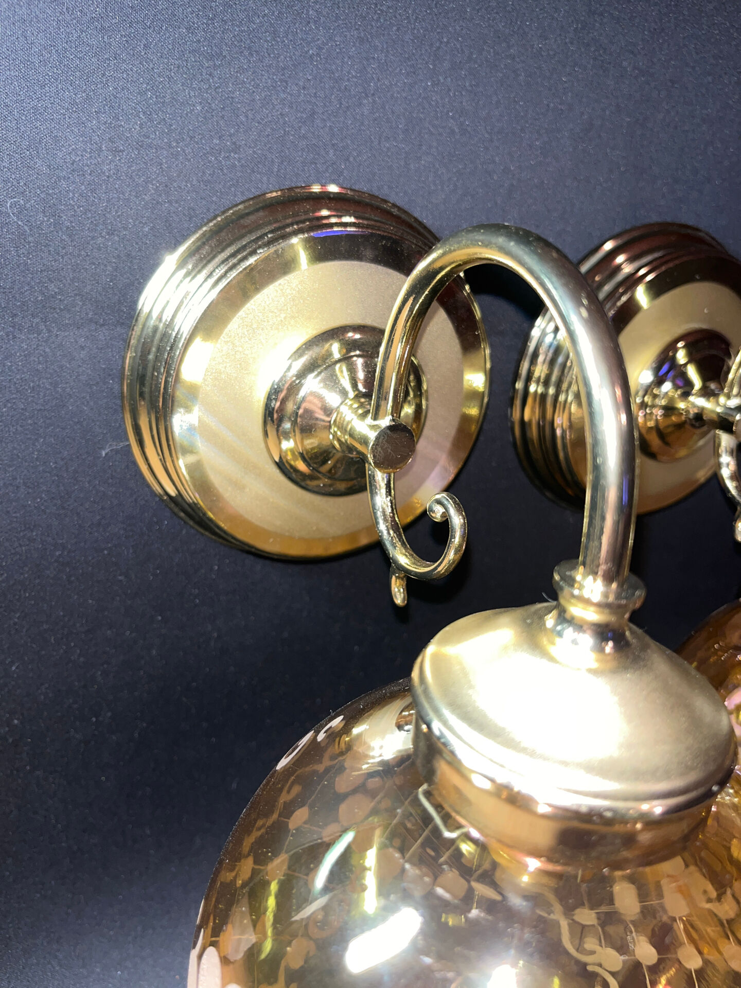 Pair of vintage wall sconces in brass with amber glass globes.