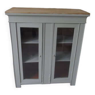 Vintage display cabinet sublimated in verdigris, 2 doors with beveled and cut windows, wooden top.