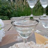 11 bottle-bottom bistro glasses with silver edging, early 20th century