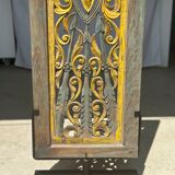 Rectangular Indonesian construction element with blue and yellow plant in carved wood