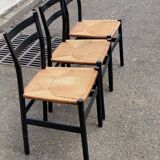 4 black Scandinavian chairs with solid wood and cord.