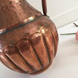 Pitcher-shaped vase in hammered copper