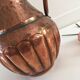 Pitcher-shaped vase in hammered copper