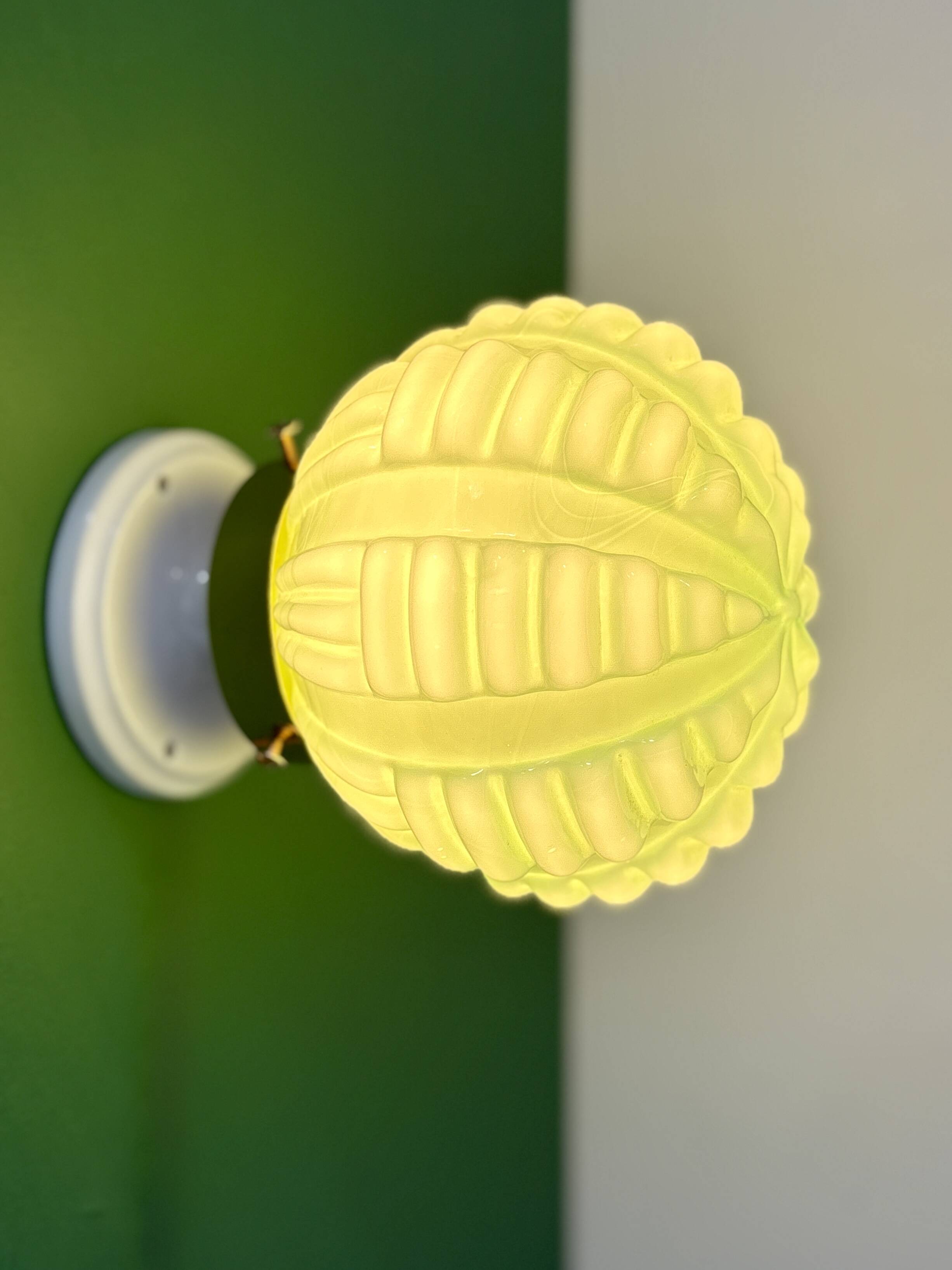 Vintage Art Deco globe wall light in pale green opaline.
