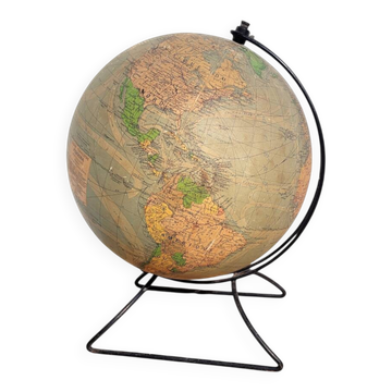 Old illuminated globe world map made of glass and paper.