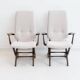 Pair of varnished wooden reclining armchairs, upholstered in lightweight fabric.