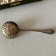 Old sauce pot and silver metal spoon