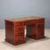 Antique mahogany desk with leather and bronze writing pad, 20th century.