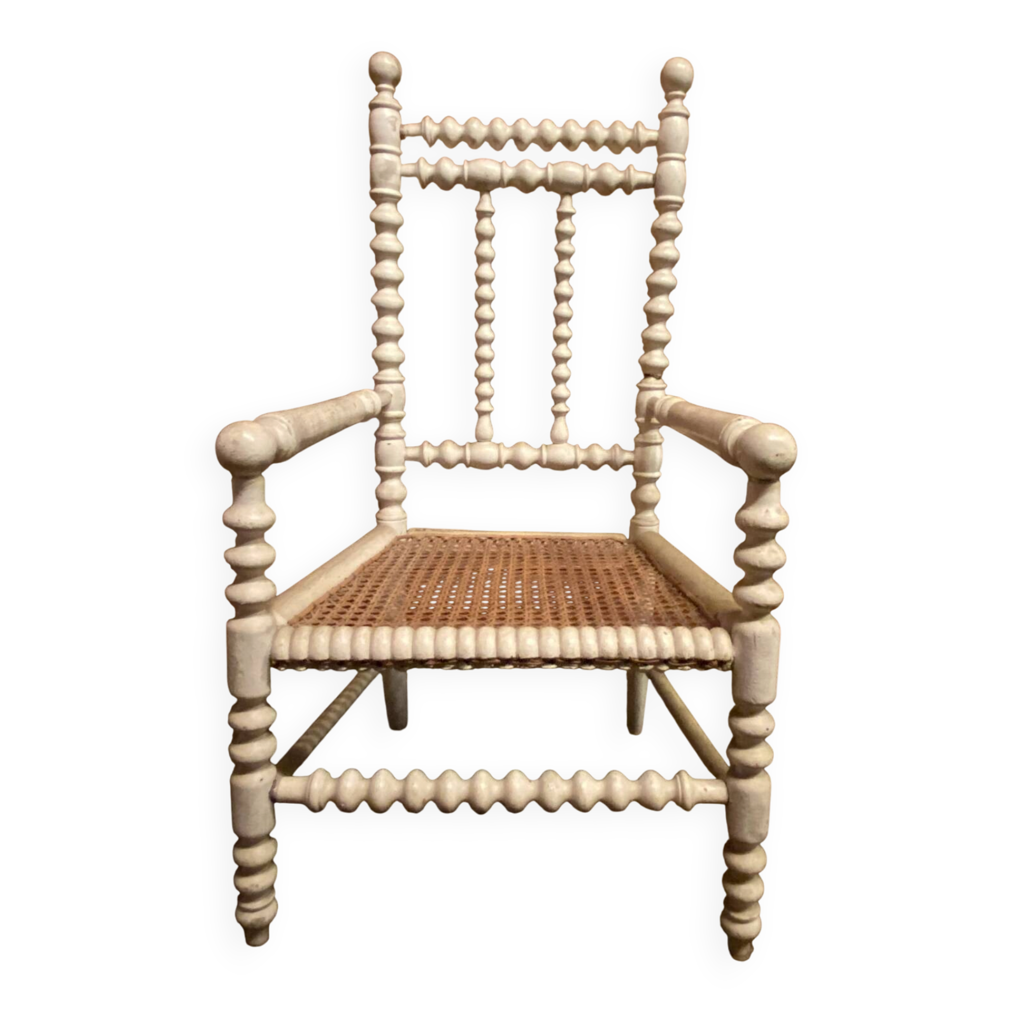 Antique wooden child's chair with turned legs and caning, white patina.