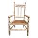 Antique wooden child's chair with turned legs and caning, white patina.