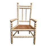 Antique wooden child's chair with turned legs and caning, white patina.