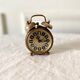 Small alarm clock old vintage watch in copper brass