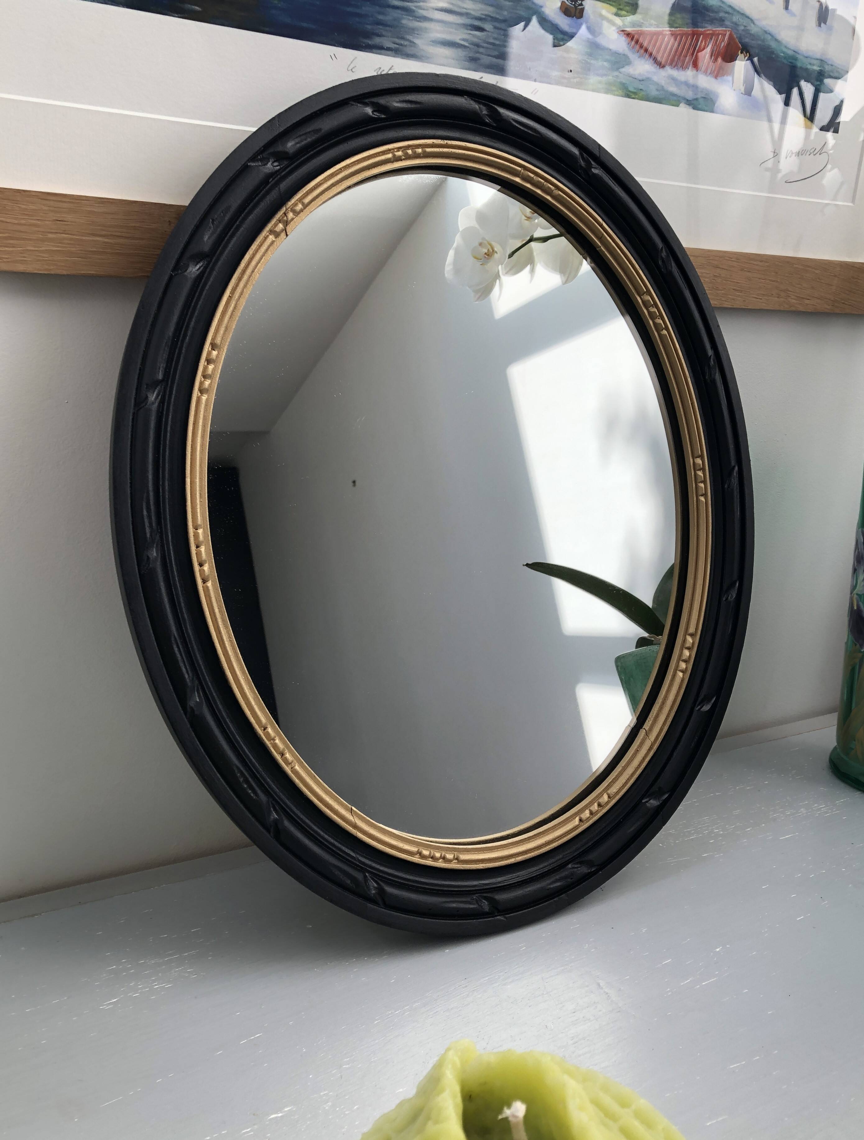 black and gold oval mirror