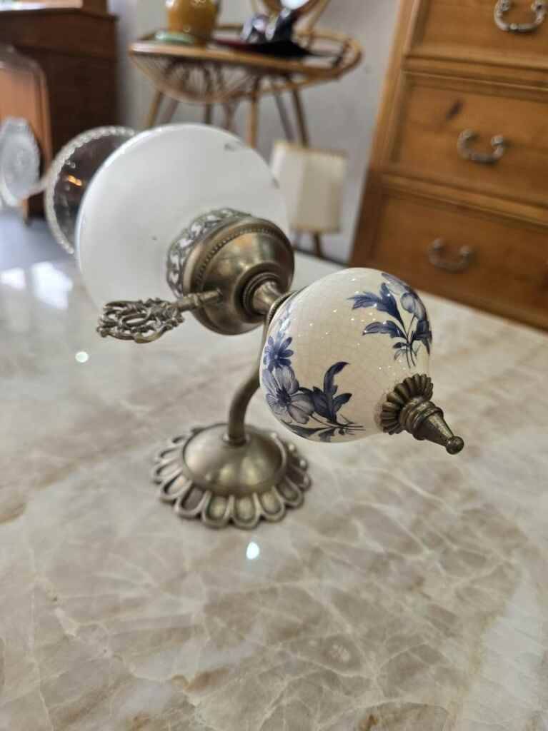 Pair of vintage wall sconces in brass, porcelain, and frosted glass.