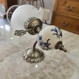 Pair of vintage wall sconces in brass, porcelain, and frosted glass.