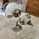 Pair of vintage wall sconces in brass, porcelain, and frosted glass.