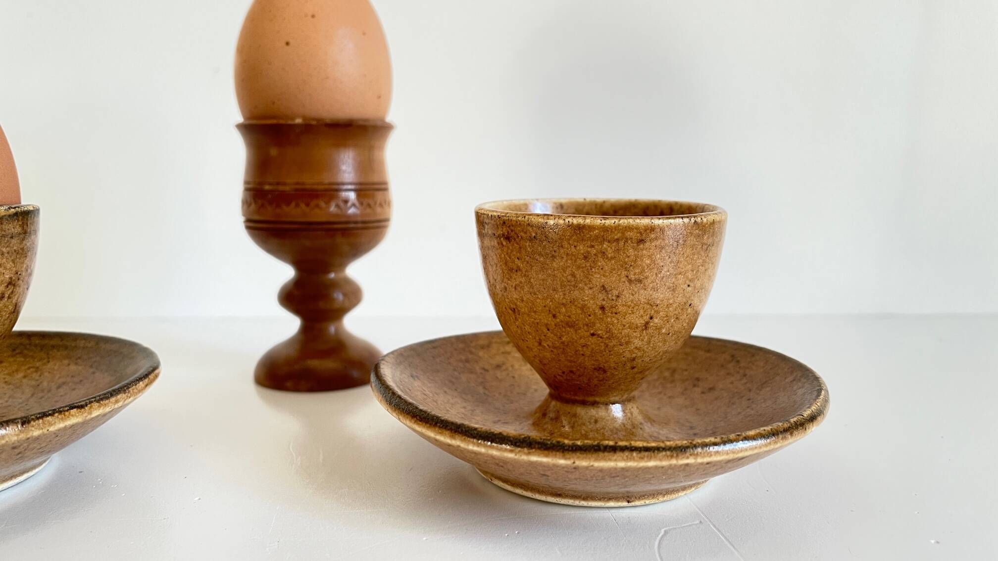 Trio of vintage ceramic and wood egg cups