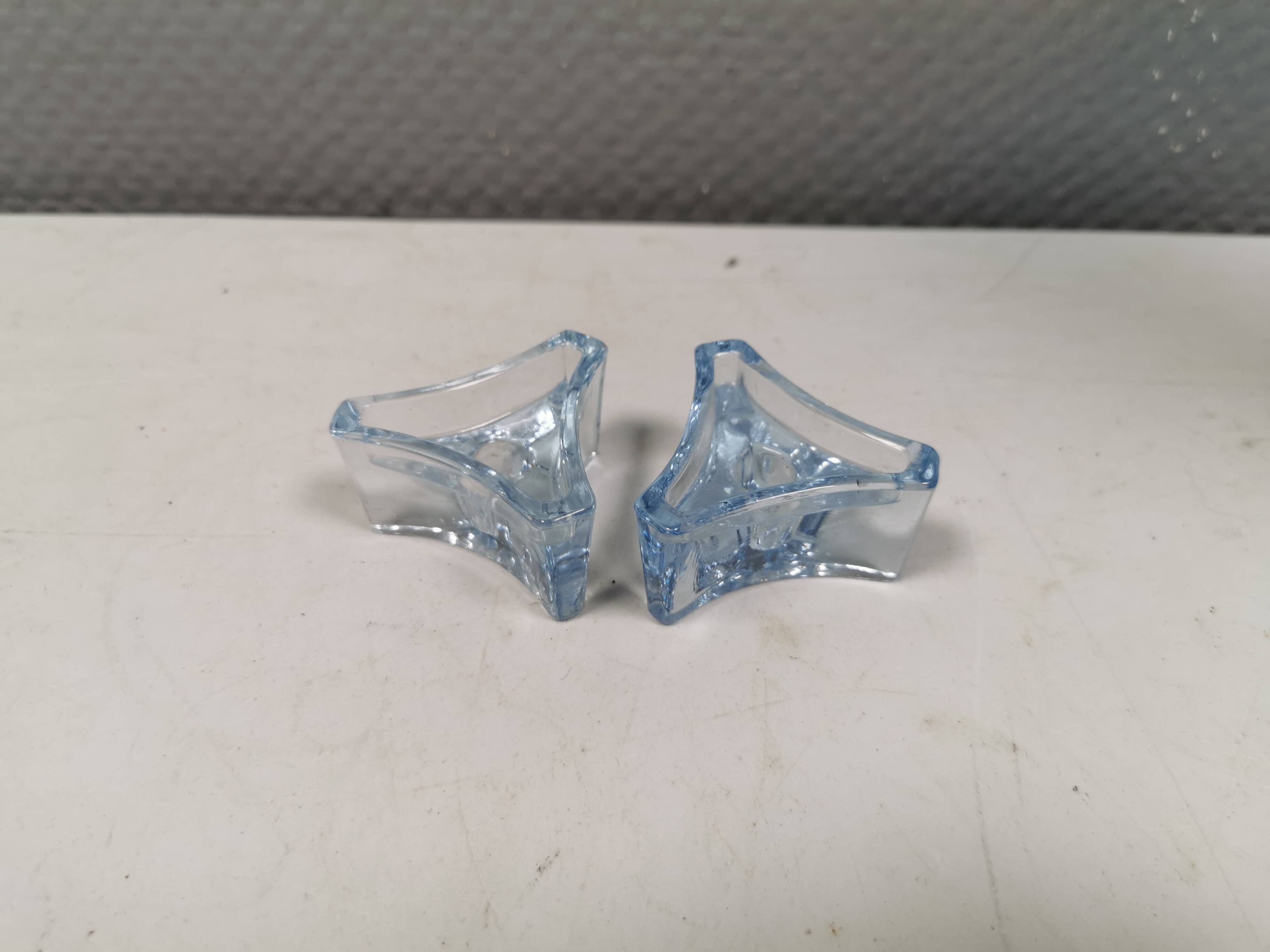 Two beautiful glass candle holders in translucent bluish glass.