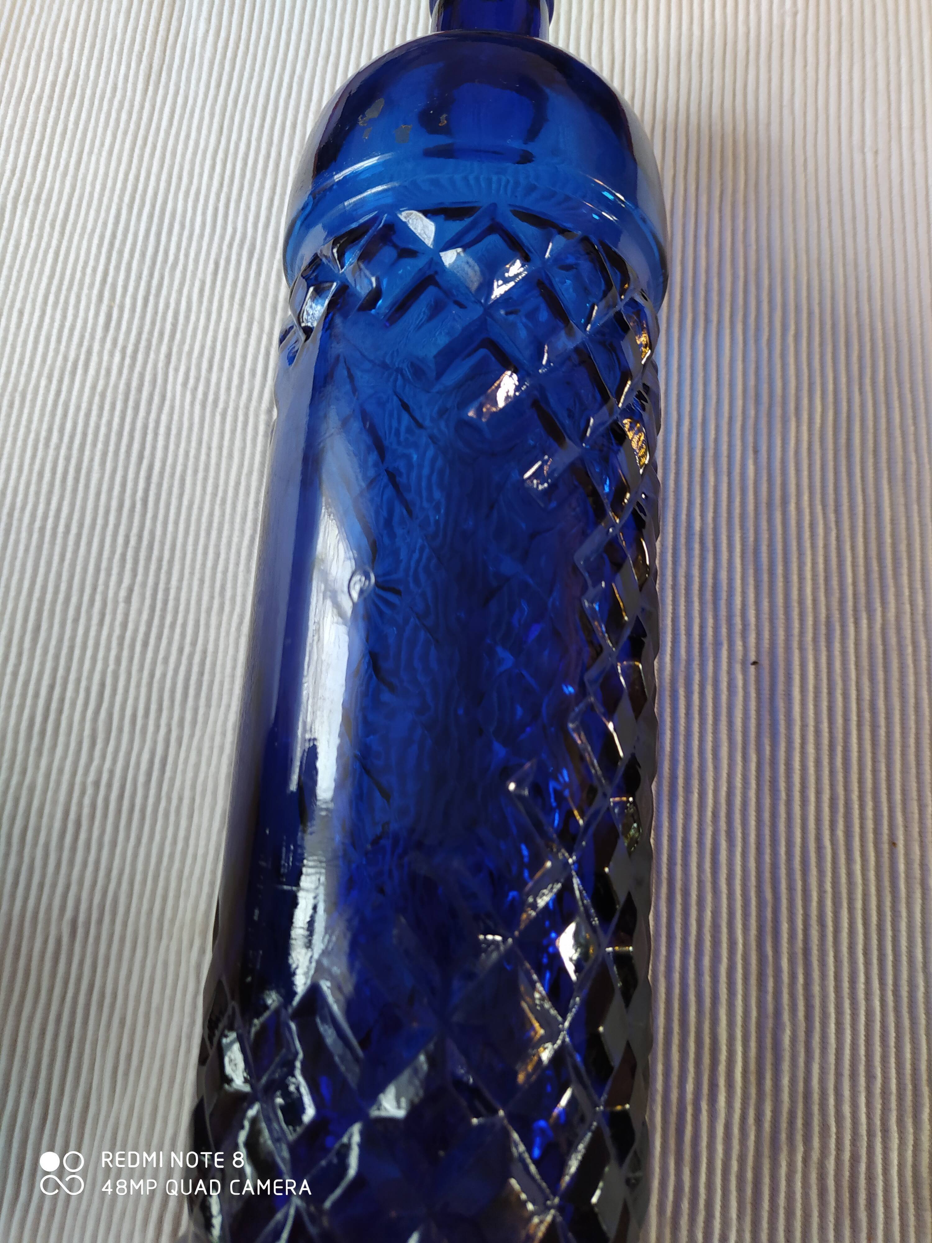 Vintage bottle in chiseled blue glass