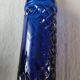 Vintage bottle in chiseled blue glass