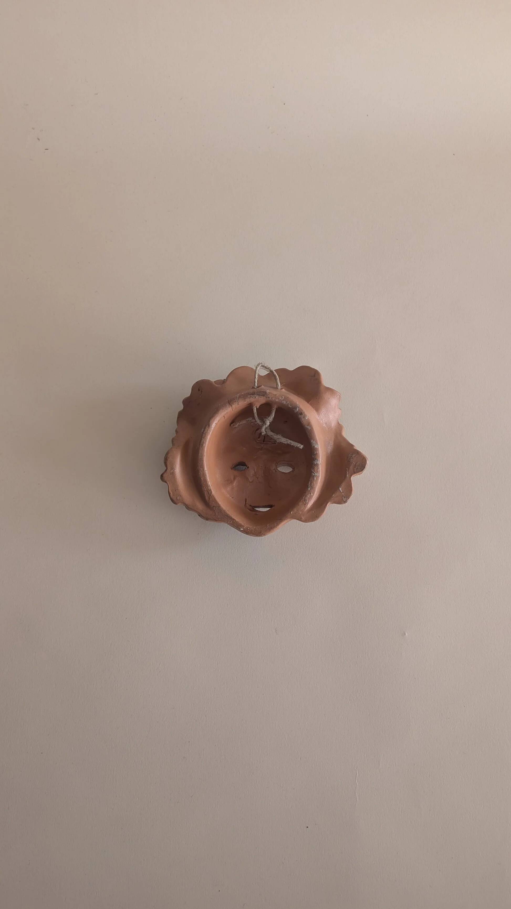 Vintage terracotta wall mask - flowery child's face