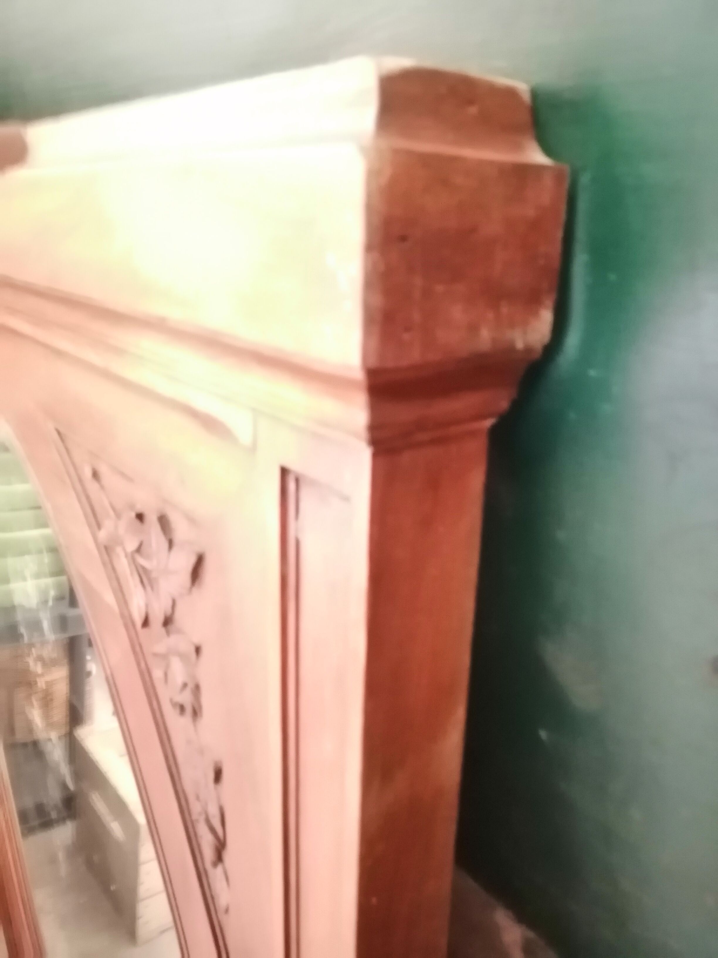 Old oval walnut wood mirror has flower carvings decoration