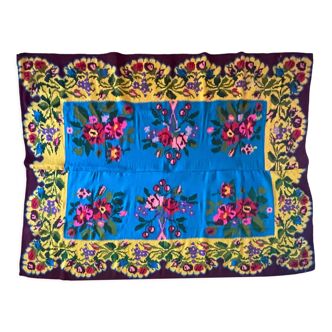 Floral wool vintage rug on blue and yellow background made by hand in Transylvania