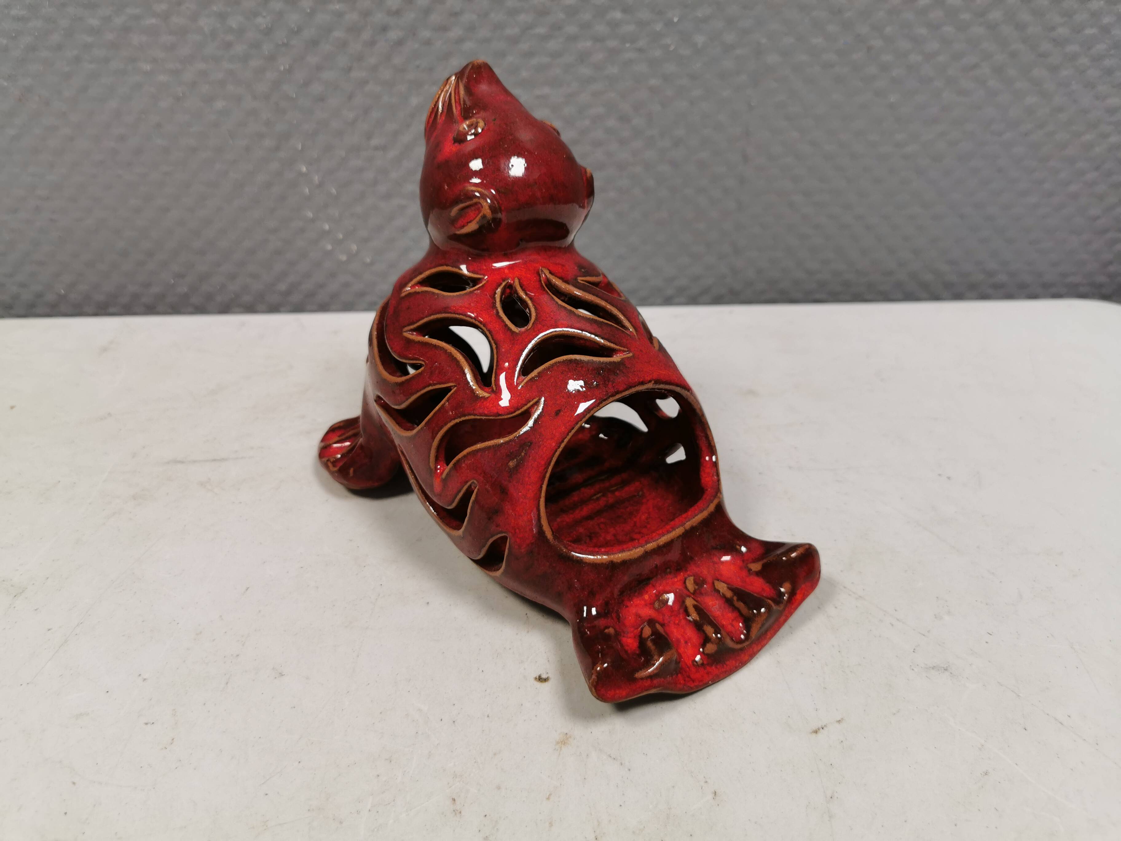 Beautiful seal in ceramic with metallic red glaze.