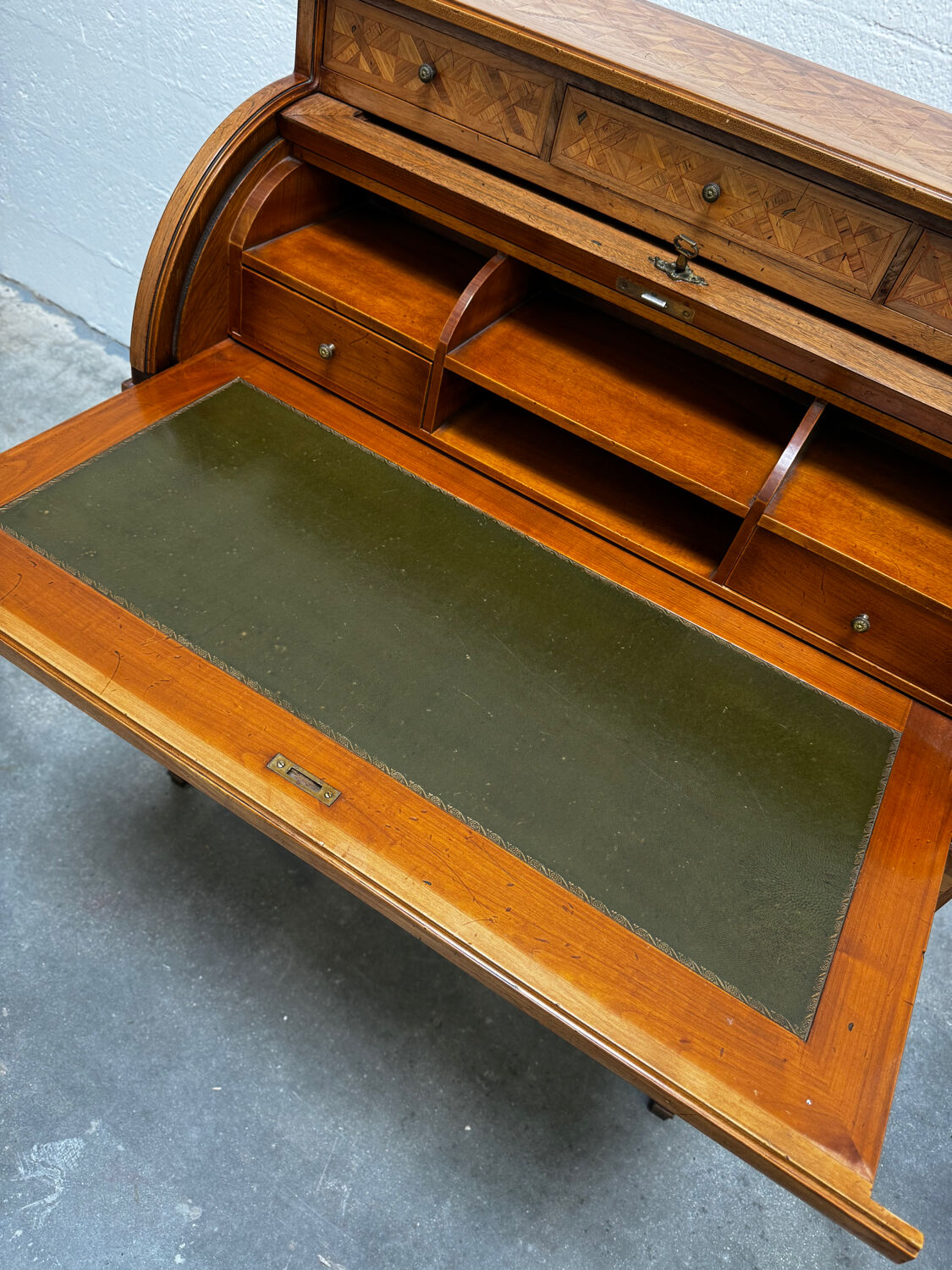 Cylinder desk with marquetry featuring a crosshatch design.