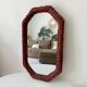 Vintage octagonal mirror in woven rattan.