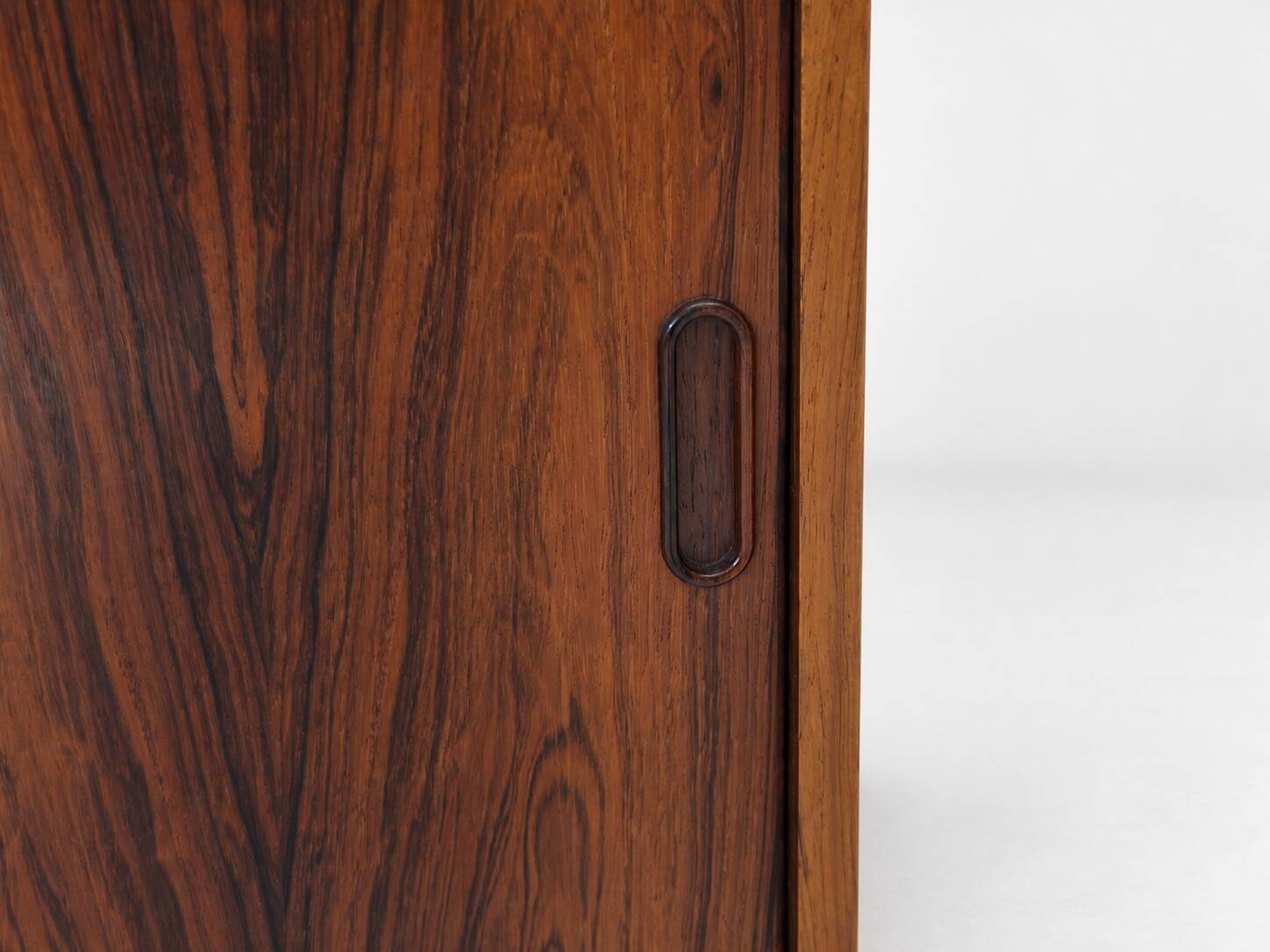 Low sideboard in rosewood with sliding doors. Denmark, 1960s