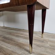 Mid-century drawer chest in mahogany, brass and glass.