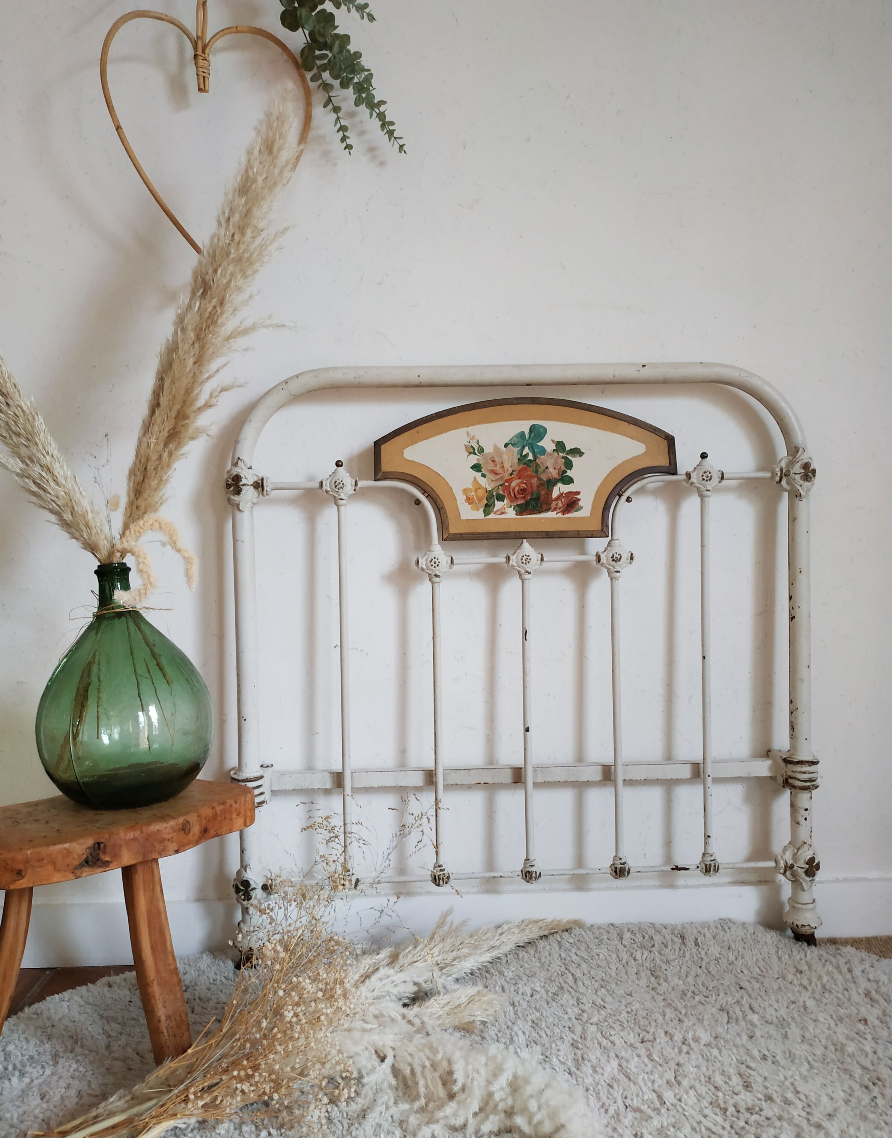 Cast-iron headboard and patinated white wood