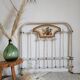 Cast-iron headboard and patinated white wood