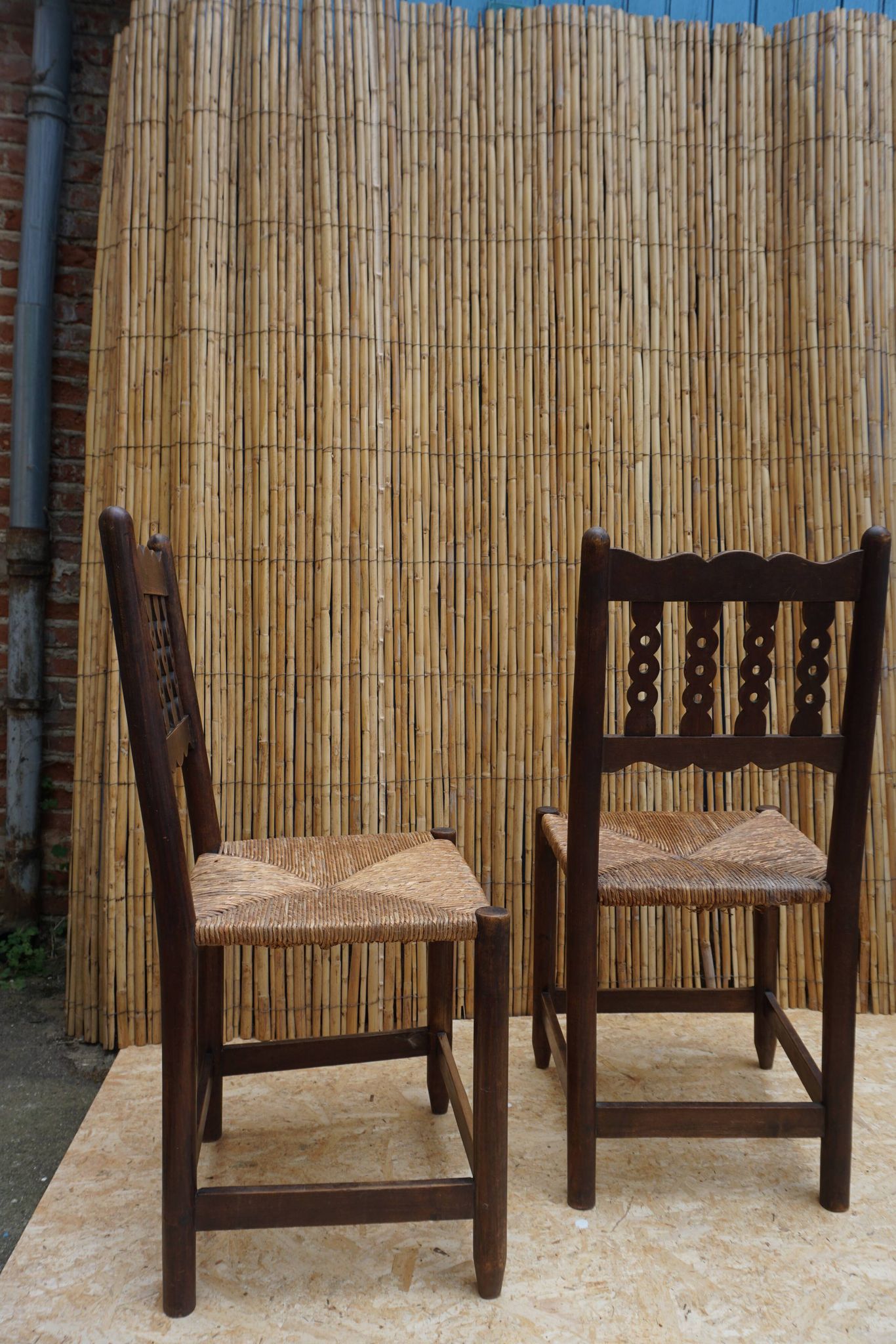 Pair of antique straw-seated farm chairs
