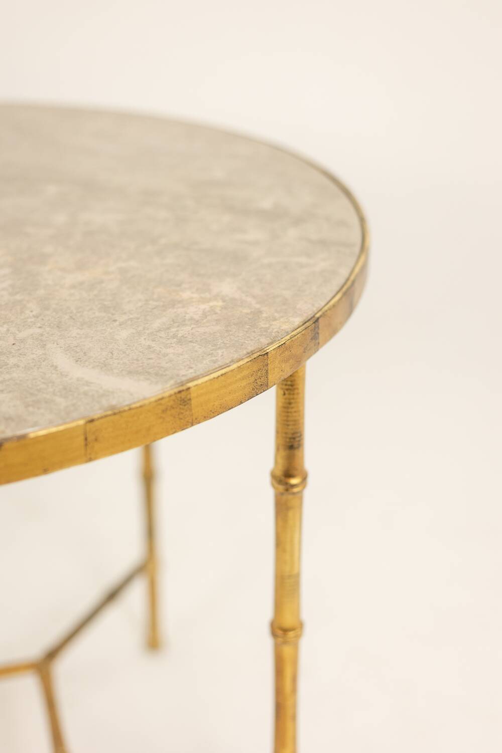 Golden metal side table with a grey marble top, 20th century.