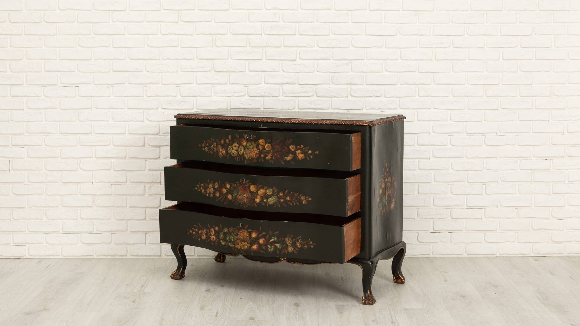 Green chest of drawers with floral decorations