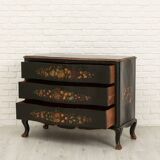 Green chest of drawers with floral decorations