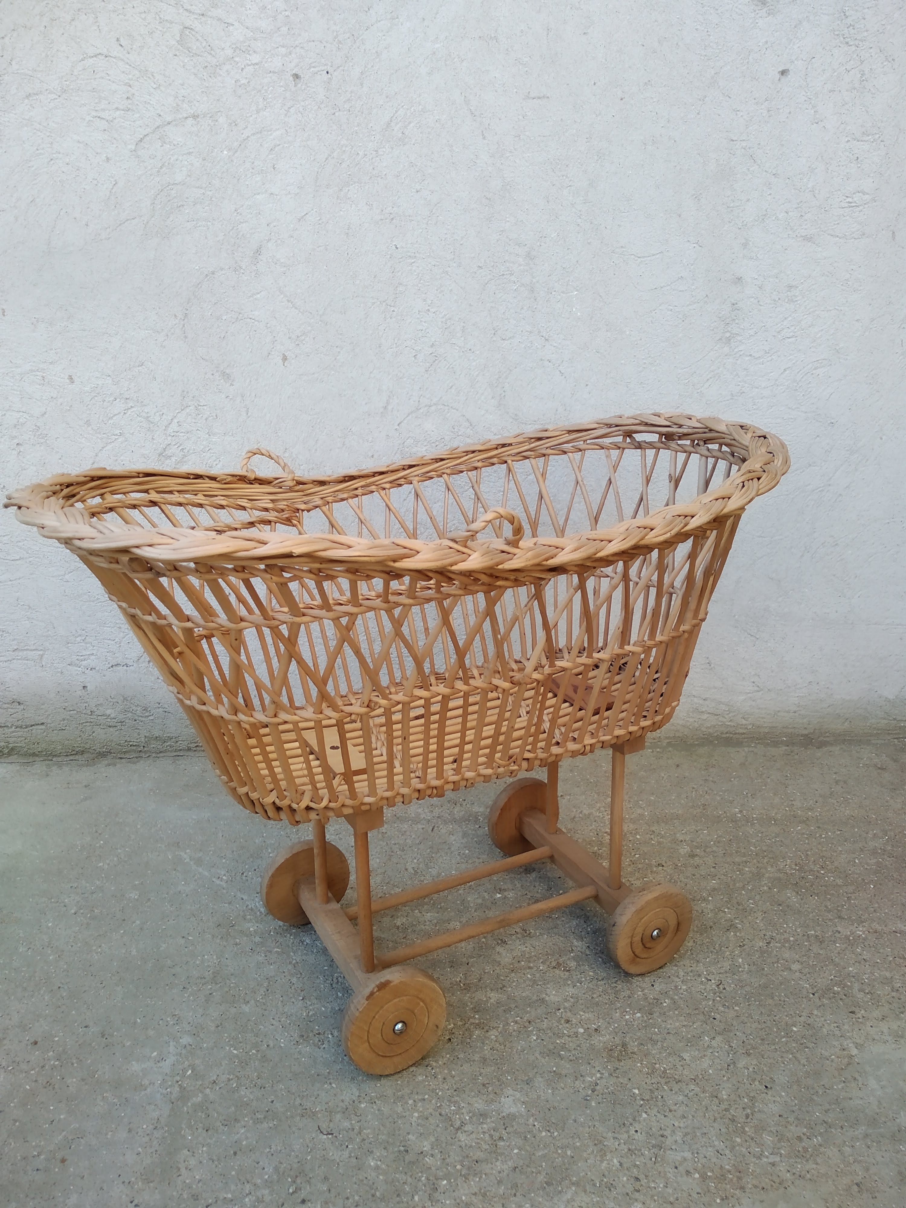 Rattan cradle for doll on vintage wheels