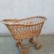 Rattan cradle for doll on vintage wheels