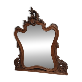 Mirror with beveled edges and highly crafted wooden frame