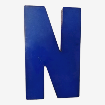 Letter N of vintage sign in blue plexiglass